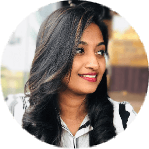 Smiling woman in the audience wearing a white shirt watching the live interactive virtual event
