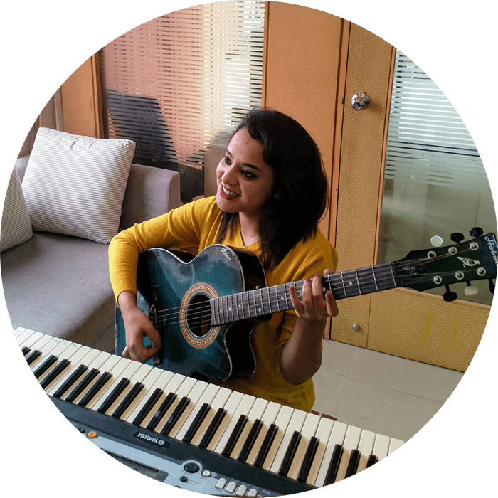 Woman playing a guitar with music keyboard in front performing in a live virtual event   